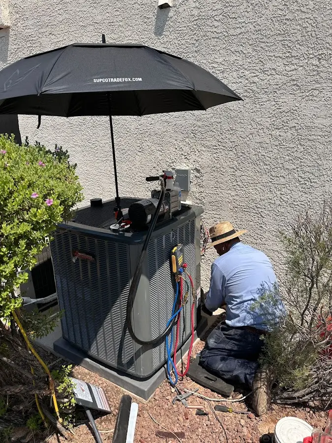 HVAC technician performing outdoor AC maintenance in Lower Moreland