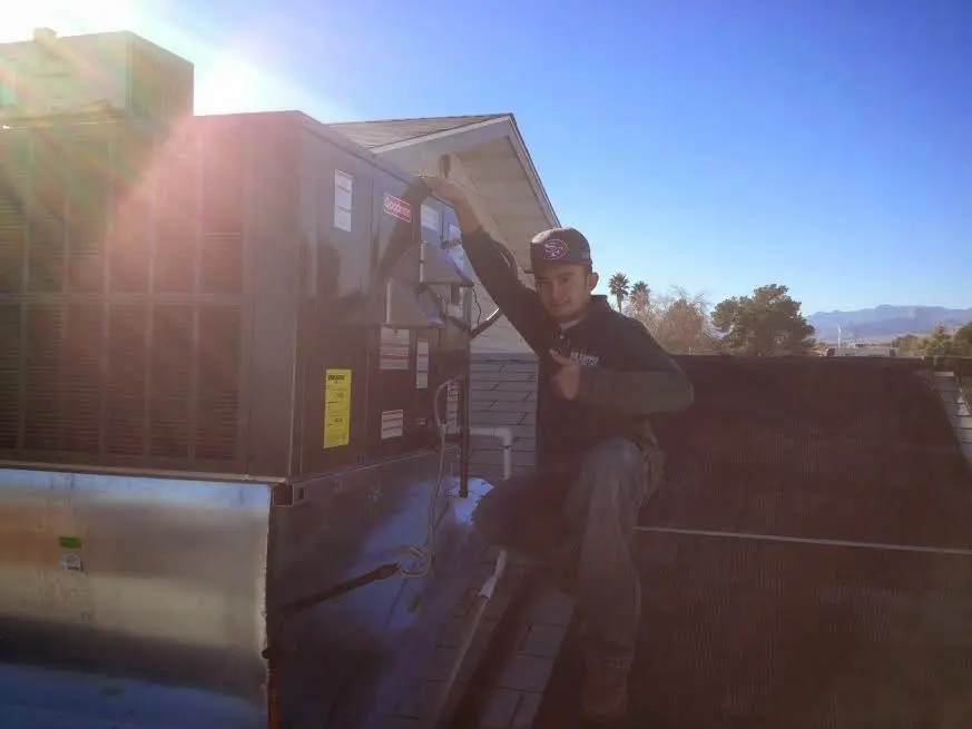 HVAC technician performing HVAC Inspection on a rooftop unit in Lower Moreland